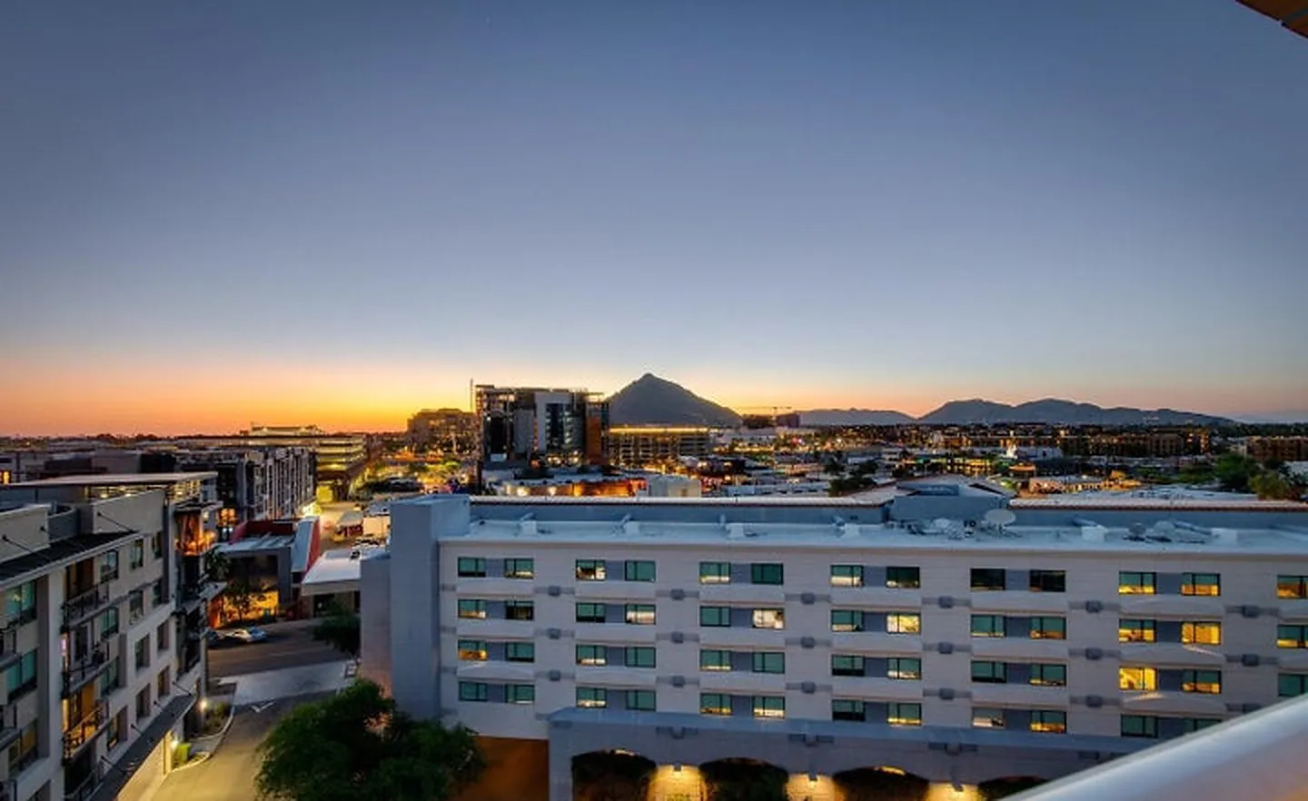 Dusk view over Old Town Scottsdale toward Camelback Mountain from Envy Residences